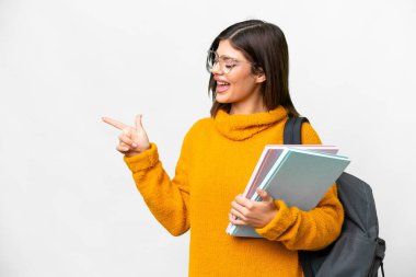 Young student woman over isolated white background pointing finger to the side and presenting a product