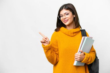Young student woman over isolated white background pointing to the side to present a product