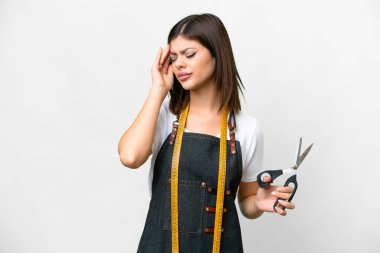 Seamstress woman over isolated white background with headache
