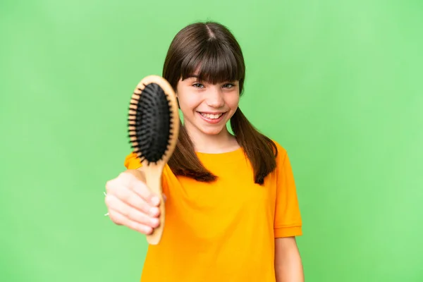 Little caucasian girl with hair comb over isolated background with happy expression