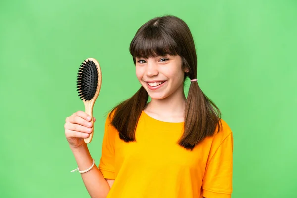 Little caucasian girl with hair comb over isolated background smiling a lot
