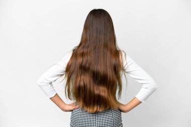 Young girl over isolated white background in back position