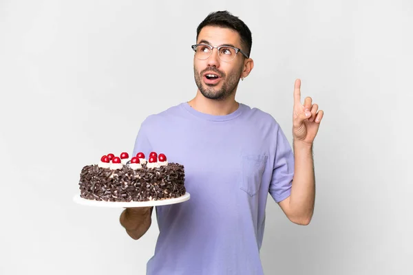 若いですCaucasian男保持誕生日ケーキ隔離された上に白の背景考え方指アップ — ストック写真