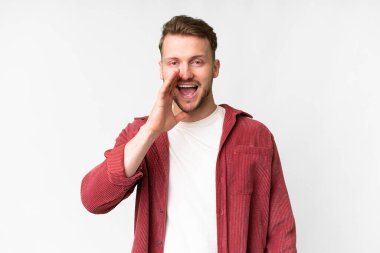 Young handsome caucasian man over isolated white background shouting with mouth wide open