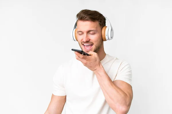 Young Handsome Caucasian Man Isolated White Background Listening Music Mobile — Stock Photo, Image