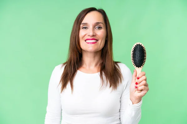 Middle age woman with hair comb over isolated chroma key background smiling a lot