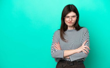 Young Russian woman isolated on green background with unhappy expression