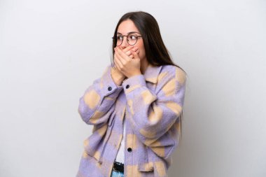 Young girl isolated on white background covering mouth and looking to the side