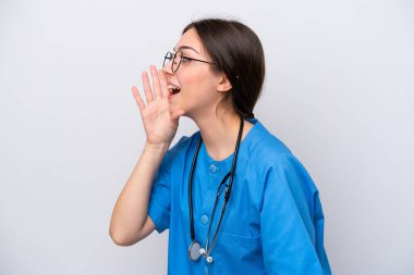 surgeon doctor woman holding tools isolated on white background shouting with mouth wide open to the lateral
