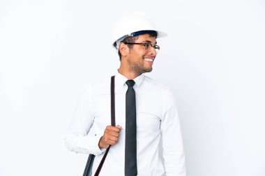 Miğferli ve elinde planları olan Brezilyalı mimar.