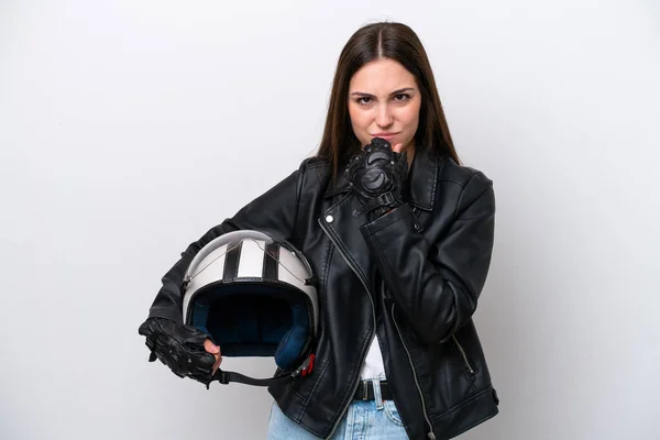 Young girl with a motorcycle helmet isolated on white background having doubts