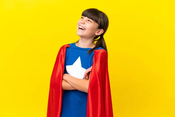Little super hero kid isolated on purple background happy and smiling