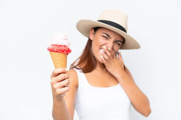 Young caucasian woman with a cornet ice cream isolated on white background with surprise and shocked facial expression