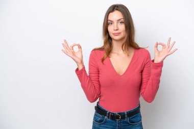 Beyaz arka planda Zen pozisyonunda beyaz tenli genç bir kadın.