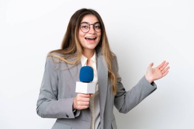 Young caucasian TV presenter woman isolated on white background with shocked facial expression