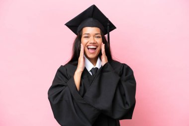 Young university Colombian woman graduate isolated on pink background with surprise and shocked facial expression
