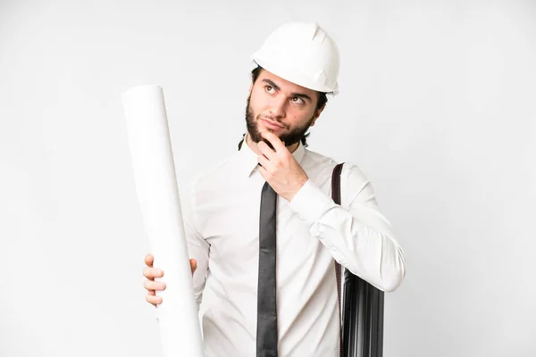 Young Architect Man Helmet Holding Blueprints Isolated White Background Looking — Foto Stock