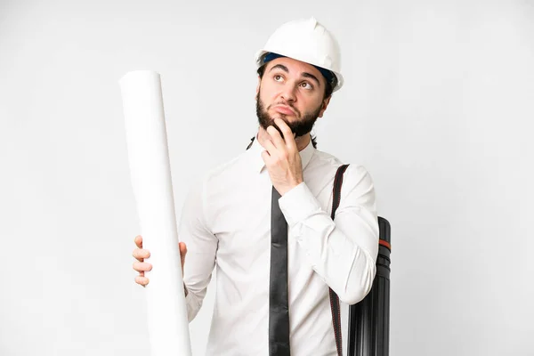 Young Architect Man Helmet Holding Blueprints Isolated White Background Having — Foto Stock