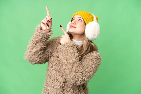 Young Girl Wearing Winter Muffs Isolated Chroma Key Background Pointing — Stock Photo, Image