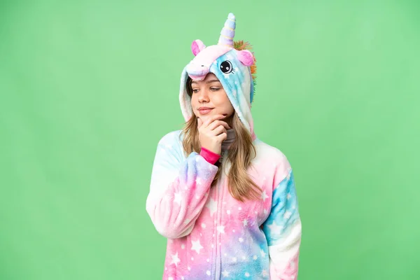 stock image Young girl with unicorn pajamas over isolated chroma key background looking to the side