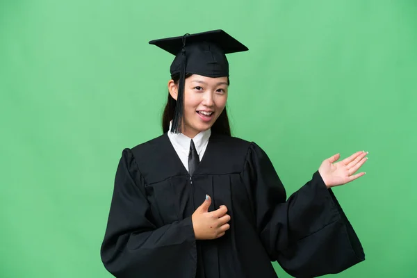 Young university graduate Asian woman over isolated background making guitar gesture