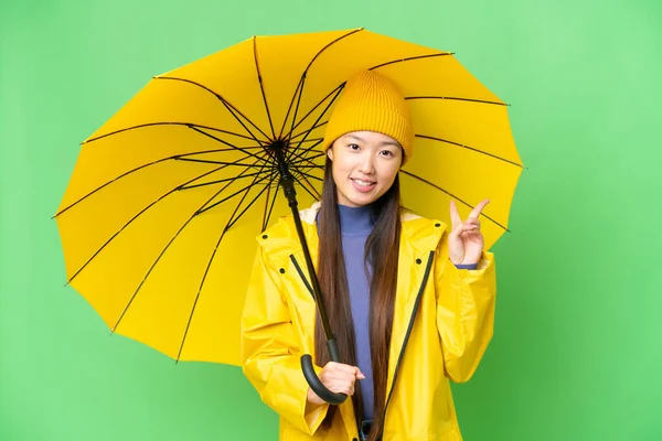 Ung Asiatisk Kvinna Med Regnsäker Rock Och Paraply Över Isolerade — Stockfoto