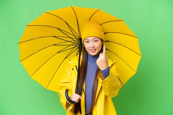Ung Asiatisk Kvinna Med Regnsäker Rock Och Paraply Över Isolerade — Stockfoto