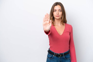 Beyaz arka planda izole edilmiş genç beyaz kadın dur hareketi yapıyor.