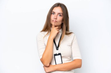 Young pretty woman with ID card isolated on white background having doubts while looking up