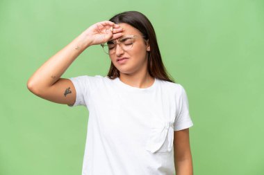 Young caucasian woman isolated on green chroma background with tired and sick expression