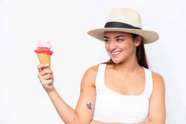 Young caucasian woman with a cornet ice cream isolated on white background with happy expression