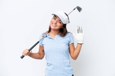 Young caucasian woman playing golf isolated on white background saluting with hand with happy expression