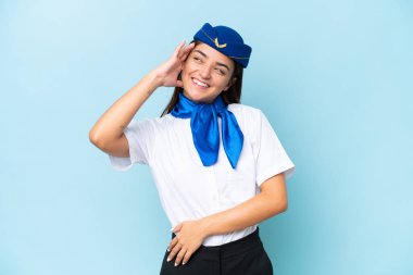 Airplane stewardess caucasian woman isolated on blue background has realized something and intending the solution