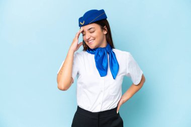 Airplane stewardess caucasian woman isolated on blue background laughing