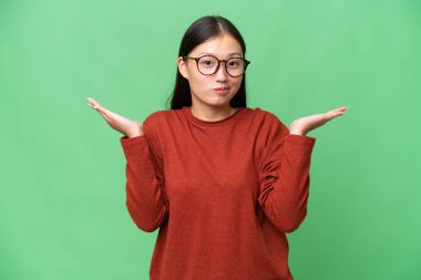 Asyalı genç bir kadın izole edilmiş arka planda ağzı açık bağırıyor.