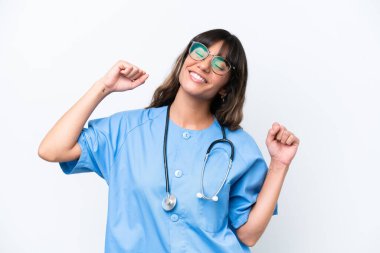 Young caucasian nurse woman isolated on white background celebrating a victory
