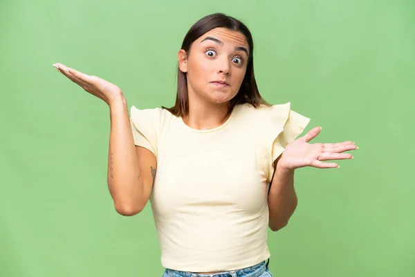 Young Caucasian Woman Isolated Green Chroma Background Making Doubts Gesture — Stockfoto