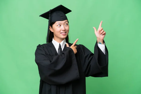 Young university graduate Asian woman over isolated background pointing with the index finger a great idea