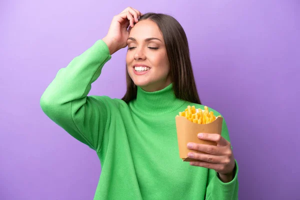 Young Caucasian Woman Holding Fried Chips Purple Background Smiling Lot — Stockfoto