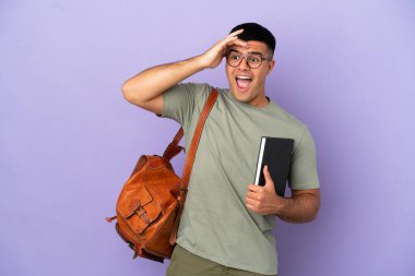 Handsome student man over isolated background doing surprise gesture while looking to the side