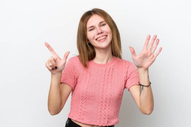 Beyaz arka planda izole edilmiş genç İngiliz kadın parmaklarıyla yediyi saydı