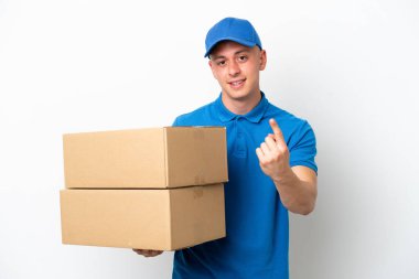 Young delivery Brazilian man isolated ops white background doing coming gesture