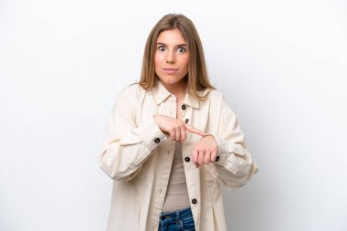 Young caucasian woman isolated on white bakcground making the gesture of being late