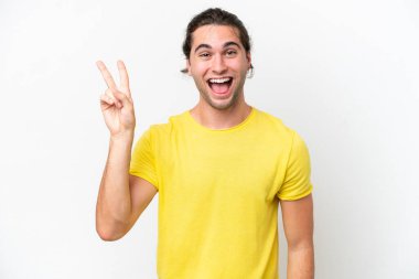 Caucasian handsome man isolated on white background smiling and showing victory sign