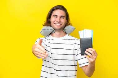 handsome Man with Inflatable Travel Pillow shaking hands for closing a good deal