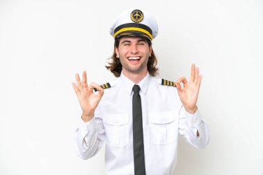 handsome Airplane pilot isolated on white background showing an ok sign with fingers