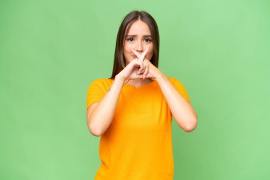 Young pretty caucasian woman over isolated background showing a sign of silence gesture