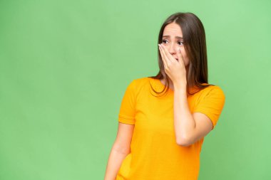 Young pretty caucasian woman over isolated background doing surprise gesture while looking to the side