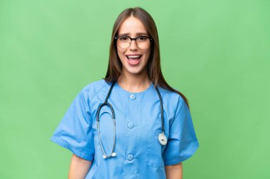 Young nurse caucasian woman over isolated background with surprise facial expression