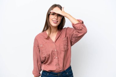 Young pretty caucasian woman isolated on white background looking far away with hand to look something